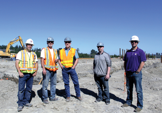 The team of Kirtley-Cole Associates LLC tours the site of a new distribution center for FedEx in Everett. Pictured (from left) are Owned Equipment Manager Steve Giangrande, Superintendent James Barquist, Vice President Todd Nelson, Senior Project Manager James Schwartz and Project Engineer Matt Pereira.